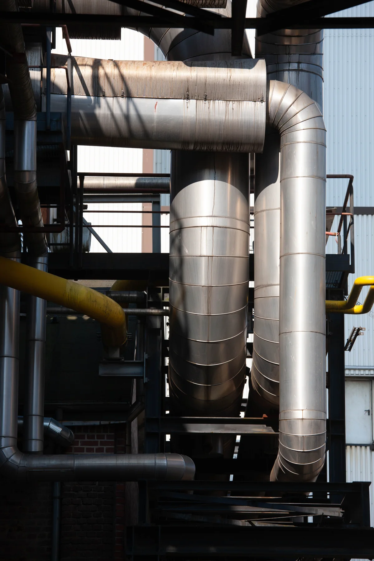 Stainless-steel industrial piping and ductwork — illustrative photograph